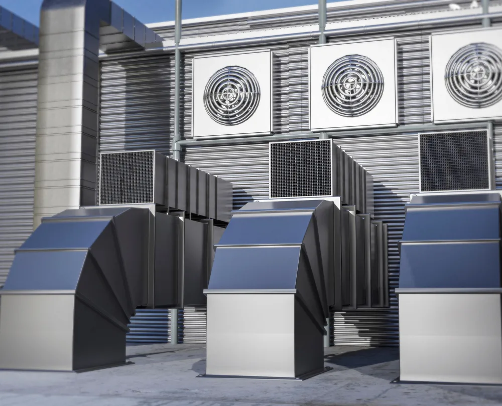 HVAC system with metallic ducts and air conditioning units mounted on a building exterior.