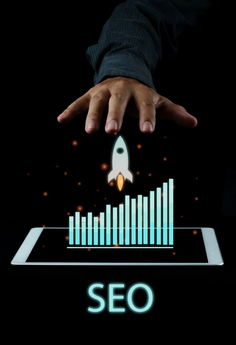 A hand hovering over a tablet screen displaying a bar chart with increasing values, symbolizing growth or SEO performance. A rocket icon is launching from the top of the chart, further emphasizing the idea of rapid growth and progress in SEO rankings.